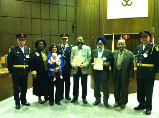 The Multi-Faith Support Team receiving their Gold Medal alongside Halton Regional Police officers in the Region's council chambers, March 2011.