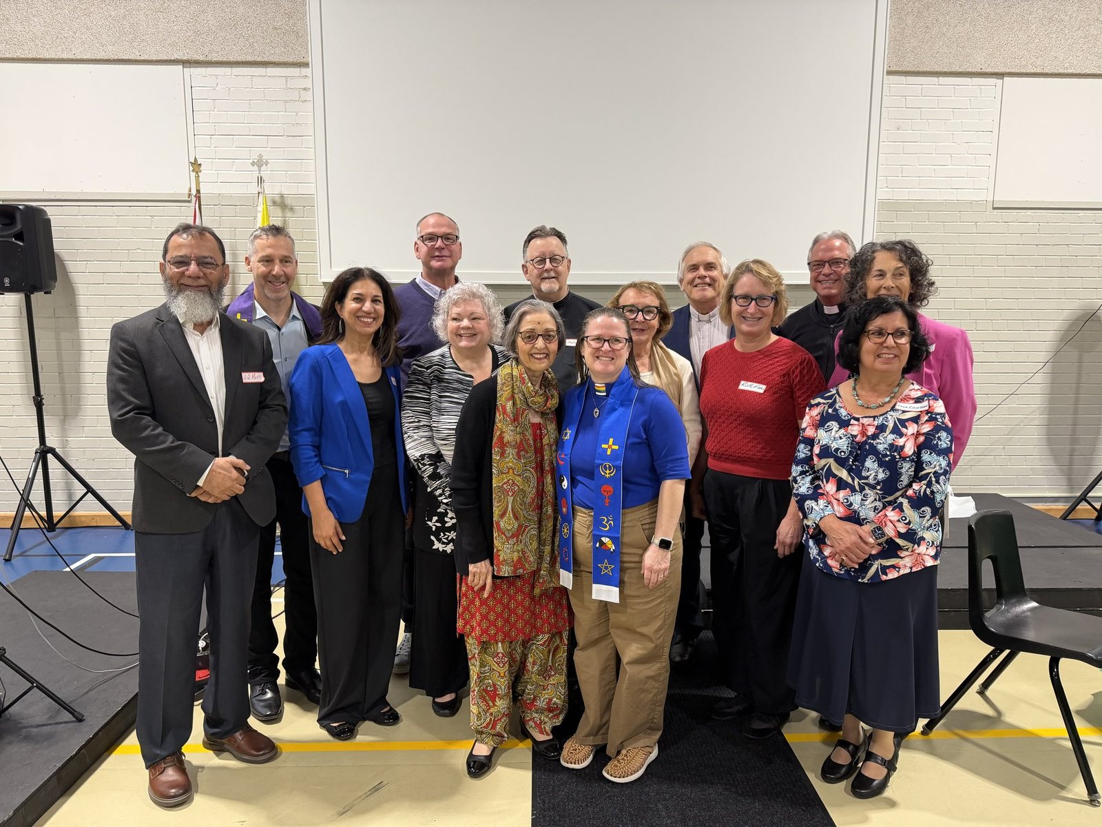 Council members and faith leaders, 14 October 2026 — among them Imam Abdul-Qayyum Mufti (left), Vida Rosen, the Rev. Malcolm French scp, Pravin Lata Sharma, the Rev. Deborah Laforet in the interfaith stole, and the Rev. Dr. Mòrar Murray-Hayes